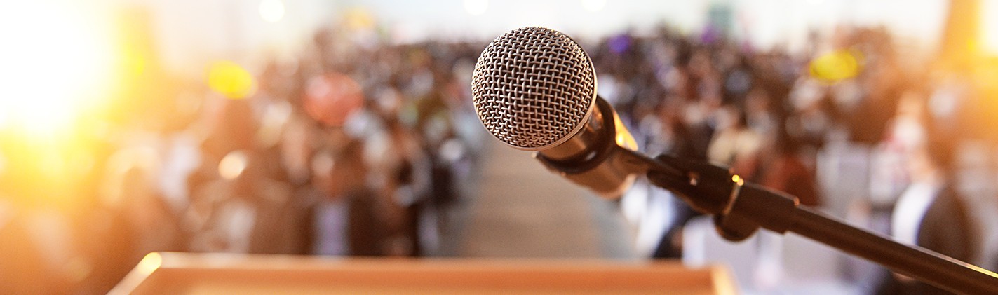 Microphone at podium in front of crowd