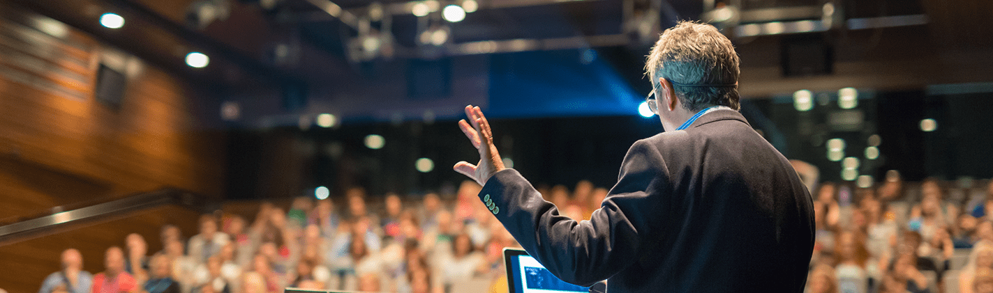 Man giving talk in auditorium