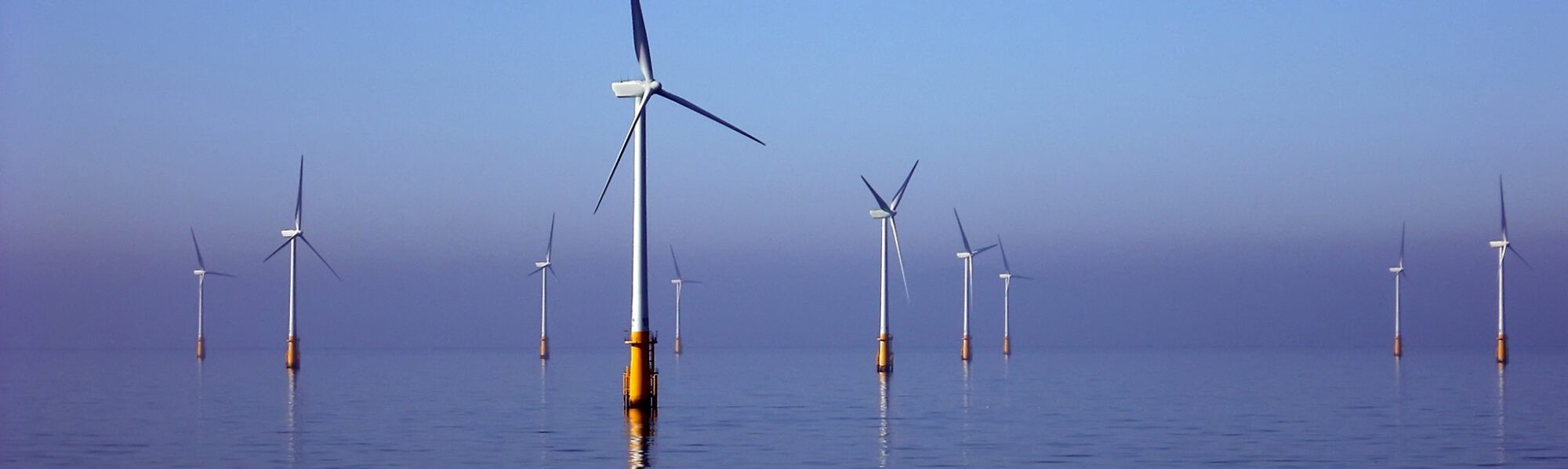 Wind turbines in an ocean, supporting sustainability