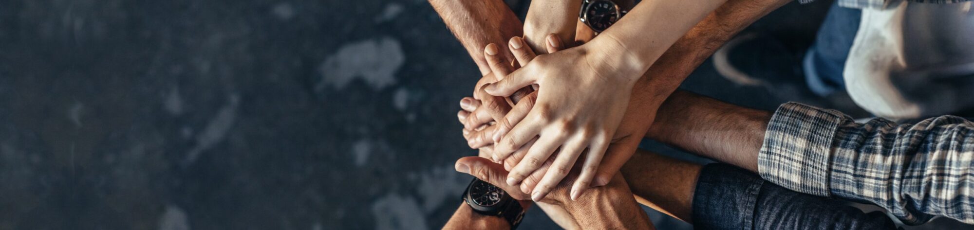 Group of people touching hands