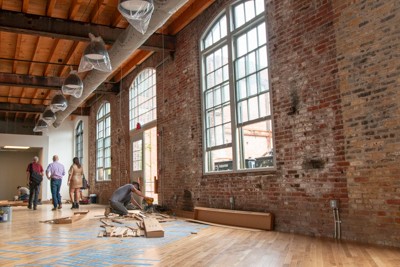 Image of people walking in Taft Communications Roebling office space that is under construction